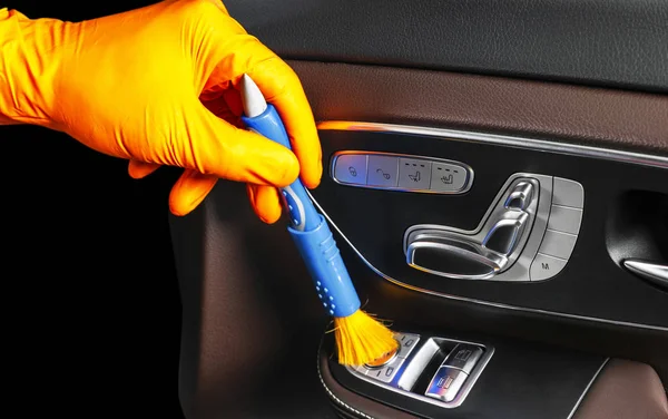 A man cleaning car with brush. Car detailing or valeting concept. Selective focus. Car detailing. Cleaning with sponge. Worker cleaning. Car wash concept solution to clean