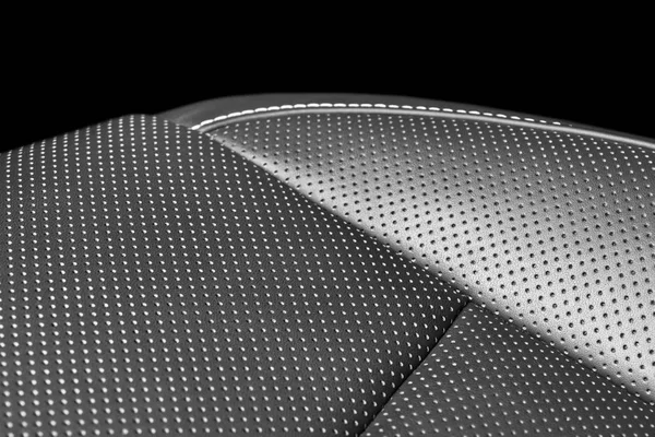 Modern luxury car leather interior. Part of leather car seat details with white stitching. Interior of prestige car. Comfortable perforated leather seats. Perforated leather. Car detailing. Black and white — Stock Photo, Image