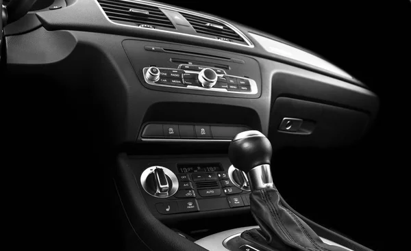 Modern Luxury sport car inside. Interior of prestige car. Black Leather. Car detailing. Dashboard. Media, climate and navigation control buttons. Sound system. Modern car interior details. Black and white