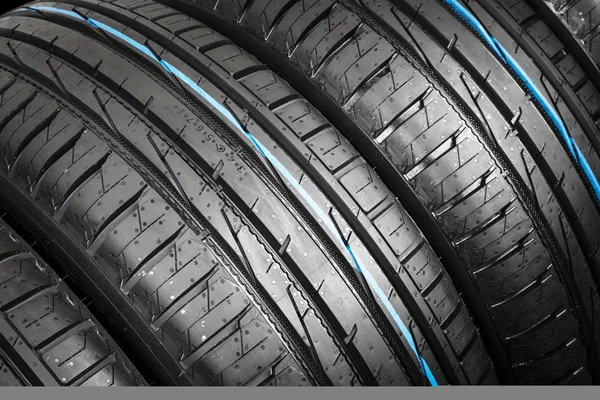 Car tire isolated on black background. Tire stack. Car tyre protector close up. Black rubber tire. Brand new car tires. Close up black tyre profile.