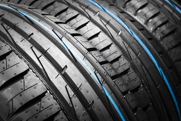 Car tire isolated on black background. Tire stack. Car tyre protector close up. Black rubber tire. Brand new car tires. Close up black tyre profile.