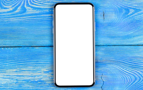 Smartphone with blank screen mock up. Smartphone isolated screen with clipping path. Mobile phone white screen with copy space on office desk. Empty space for text. Isolated white screen