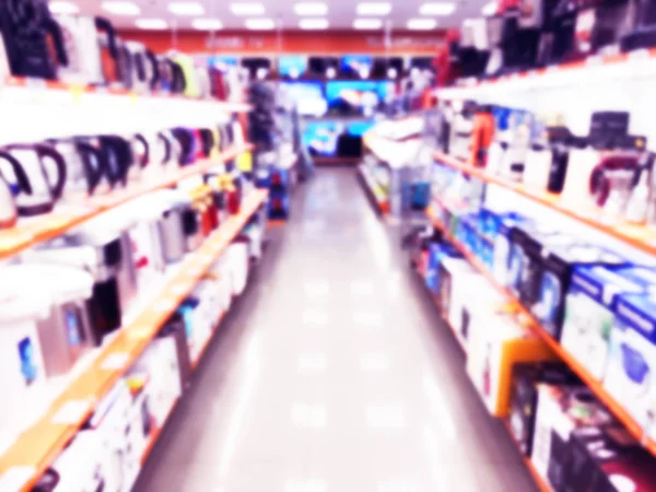 Latar belakang kabur abstrak dengan butik toko seluler di pusat perbelanjaan. Eletronic department store interior dengan bokeh cahaya kabur latar belakang. Latar belakang kabur yang tidak fokus. Blurry interior view toko ritel — Stok Foto