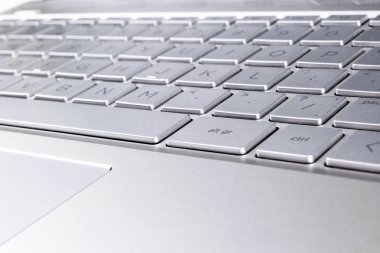 Modern gümüş dizüstü bilgisayar klavyesinin yakın çekim. Dizüstü bilgisayar klavyesi. Yeni ve ergonomik bilgisayar klavyesinin ayrıntıları. 