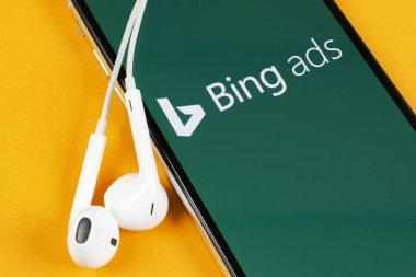Bing application icon on Apple iPhone X screen close-up. Bing ads app icon. Bing ads is online advertising application. Social media network. clipart