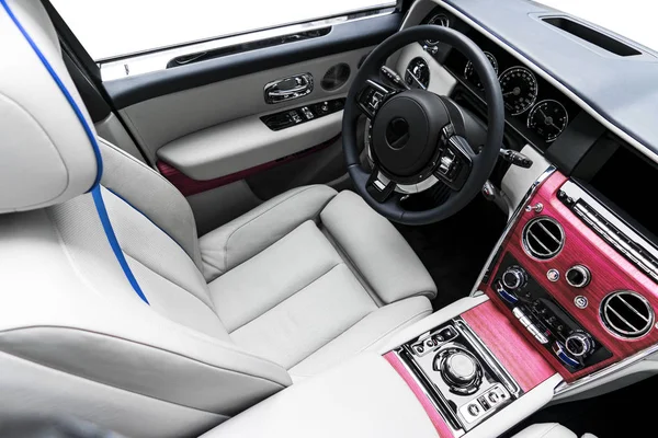 Modern luxury car white leather interior with natural wood panelModern luxury car white leather interior with natural wood panel. Part of leather car seat details with stitching. Interior of prestige modern car. White perforated leather. Car detailin