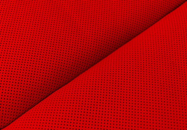 Modern luxury Car red leather interior.  Part of perforated leather car seat details. Red Perforated leather texture background. Texture, artificial leather with stitching. Comfortable perforated leather seats