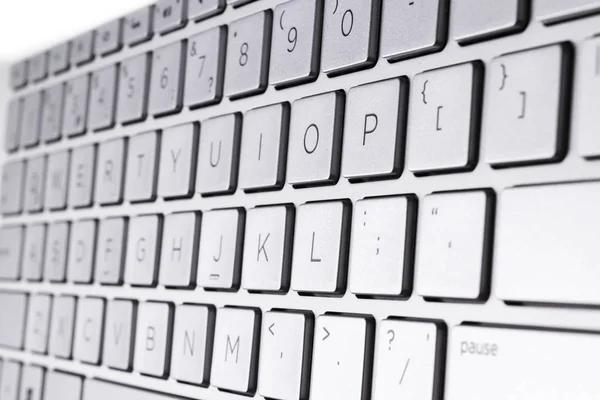 Closeup of a modern silver laptop computer keyboard. Laptop keyboard. Detail of the new and ergonomic computer keyboard. — Stock Photo, Image