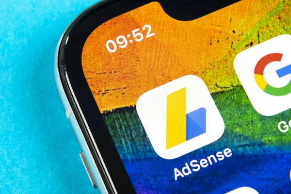 Google AdSense application icon on Apple iPhone X screen close-up. Google AdSense app icon. Google AdSense application. Social media network — Stock Photo, Image