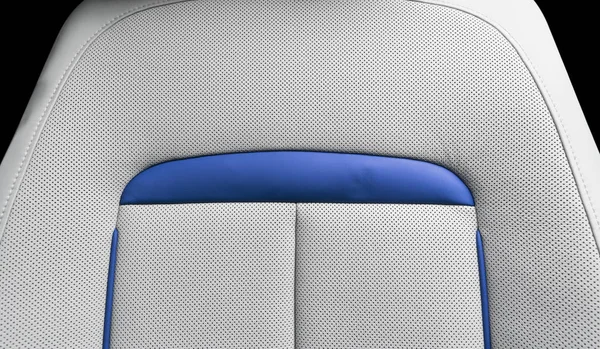 White leather interior of the luxury modern car. Perforated white leather comfortable seats with stitching isolated on black background. Modern car interior details. Car detailing. Car inside. — Stock Photo, Image