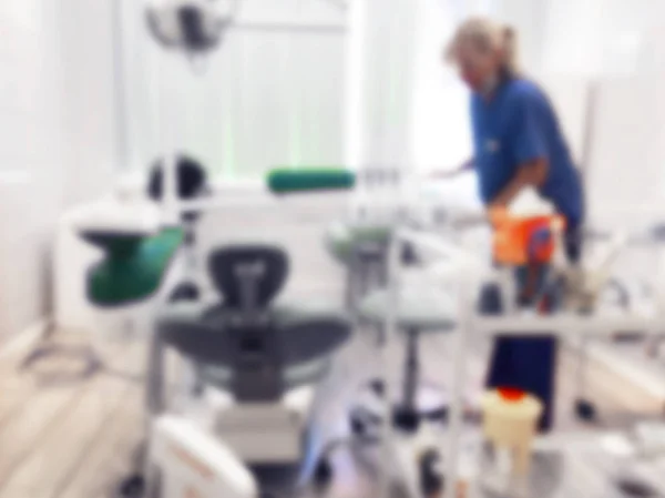Dentist office background , dental hygiene, dentists chair. Blurred view of dentist's office interior with chair and equipment. Professional dentist's equipment and blurred doctor with patient — Stock Photo, Image