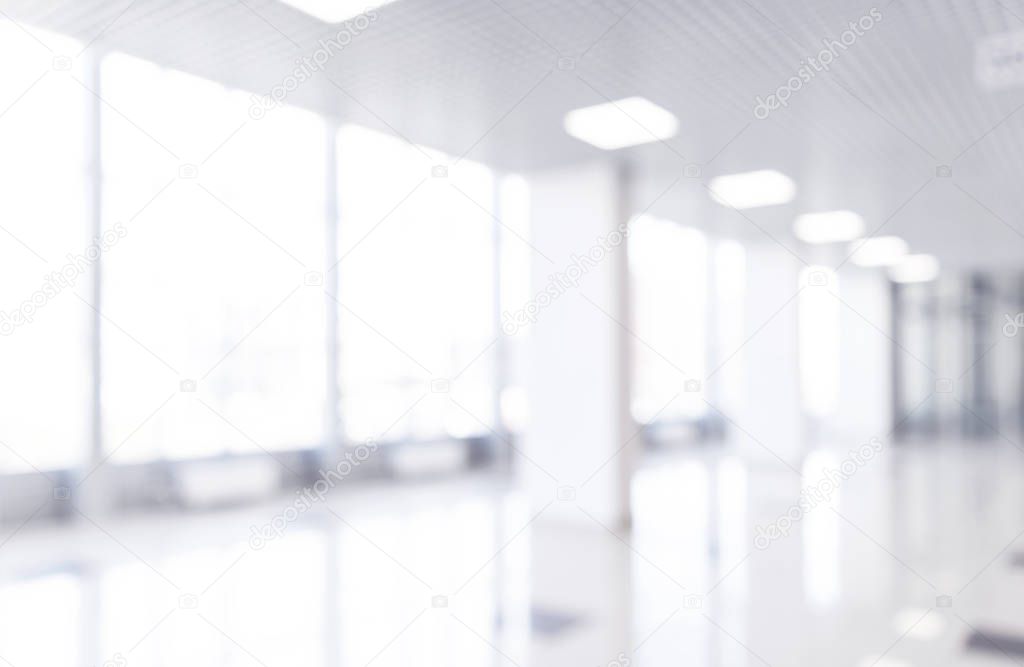 Abstract blur shopping mall corridor. Blurred retail and hall interior in department store. Defocused bokeh effect background or backdrop for business concept. Bokeh light