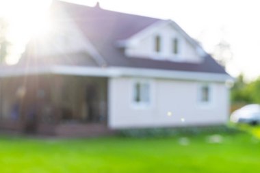 Lüks evin bulanık arkaplanı. Evin dış teması, Bokeh efektli soyut bulanık arkaplan. Bulanık ev ve çimenler