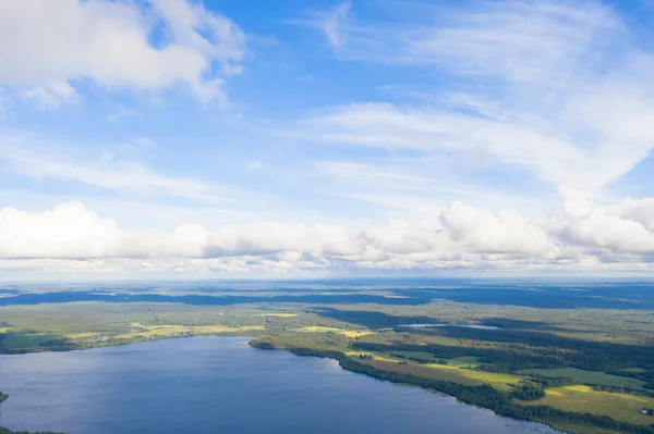 Aerial view clouds over the forest and lake. View from drone. Aerial top view cloudscape. Texture of clouds. View from above. Sunrise or sunset over clouds