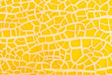 Olgun tatlı kavun arkaplanı. Olgun taze kavun ve meyve ezmesi dokusuna yakın. Sarı kavun desenli arka plan. Karpuzsuz doku