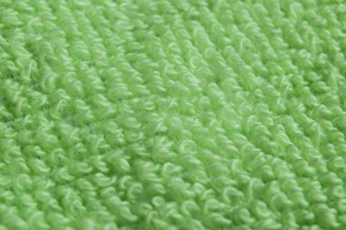 Makro yeşil pamuk kumaş dokusunu vurdu. Örtülü doğal bez dokusu. Kumaş dokusu. Sert kumaş arkaplan dokusu