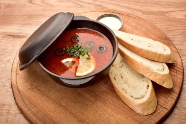 ahşap bir masa ekmek parçaları ile siyah tencerede Hodgepodge