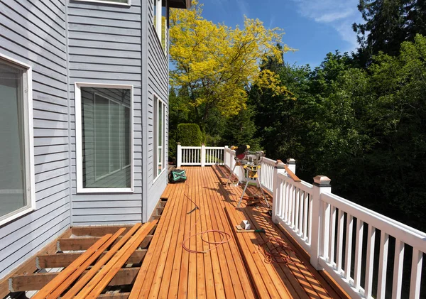 Outdoor red wooden cedar deck being remodeled with new floor boa — Stock Photo, Image