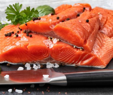 Fresh raw pacific wild king salmon fillets on natural stone with clipart