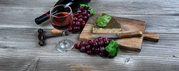Glass Red Wine Fresh Cheese Wedge Basil Leaves Grapes Rustic — Stock Photo, Image