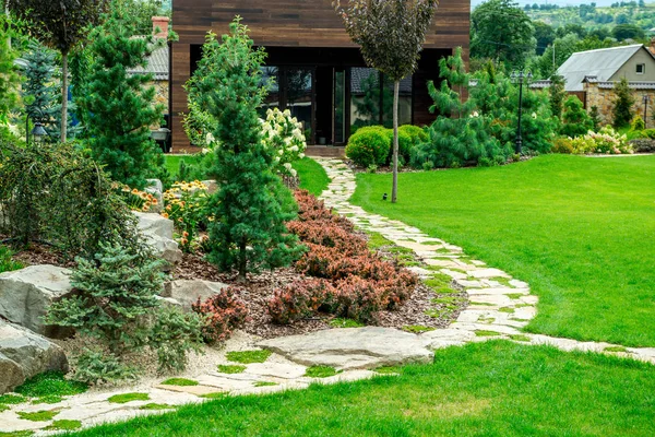 Una casa de campo con un hermoso patio trasero detrás de la casa, diseño de paisaje — Foto de Stock