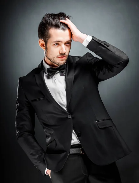 Portrait of confident handsome man in black suit with bowtie — Stock Photo, Image