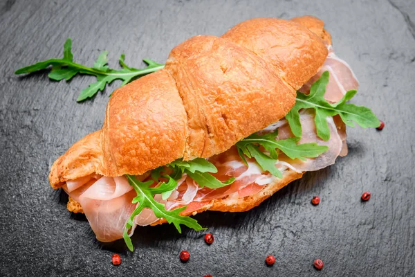 Fresh croissant with ham and salad leaf — Stock Photo, Image