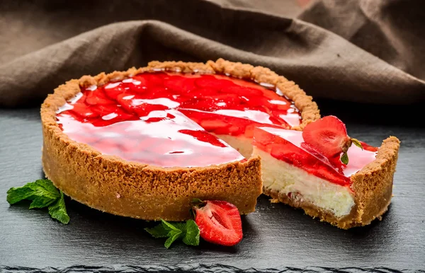 Cold cheesecake with strawberry and strawberry jelly.