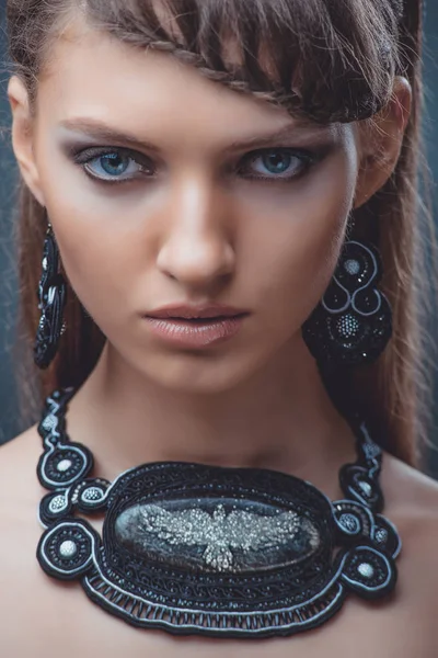 Portret pięknej kobiety z piękny makijaż i fryzurę. Z dekoracją duży kamień — Zdjęcie stockowe