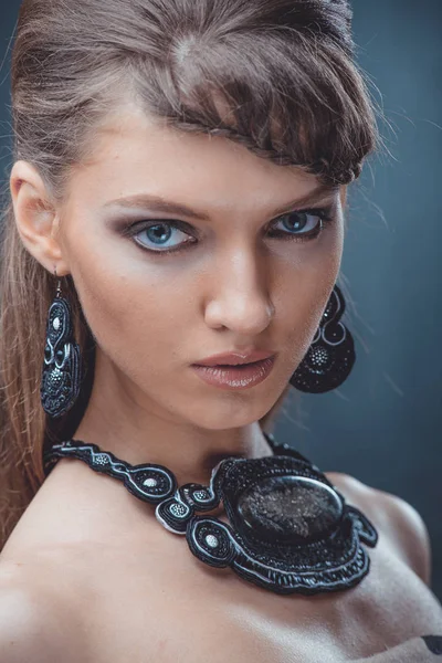 Retrato de una hermosa mujer con hermoso maquillaje y peinado. Con la decoración de una gran piedra —  Fotos de Stock