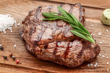 Ahşap kesme tahtasında baharatlı ızgara biftek. ahşap arkaplanda