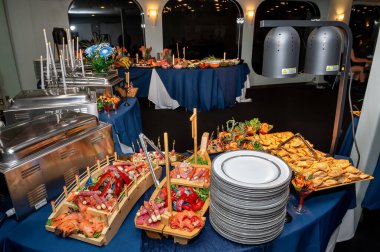 Akşam yemeğinde şık bir açık büfe gösterisi. Açık büfe, gurme yemekleri, taze ürünler ve deniz ürünleri sergileriyle bir akşam yemeği için hazır..