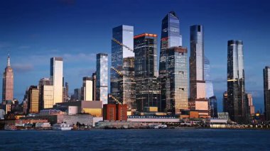 Günbatımında Hudson Yards 'ın modern gökdelenleri. New York 'taki Hudson Yardları, aydınlanmış modern gökdelenleri ile akşam ışığını yansıtıyor.