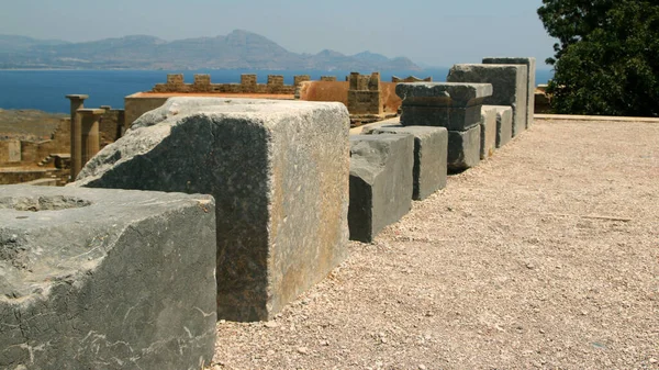 Stone bases of statues, the Acropolis of Lindos, Greece. The dedications in Greek glorify the gods