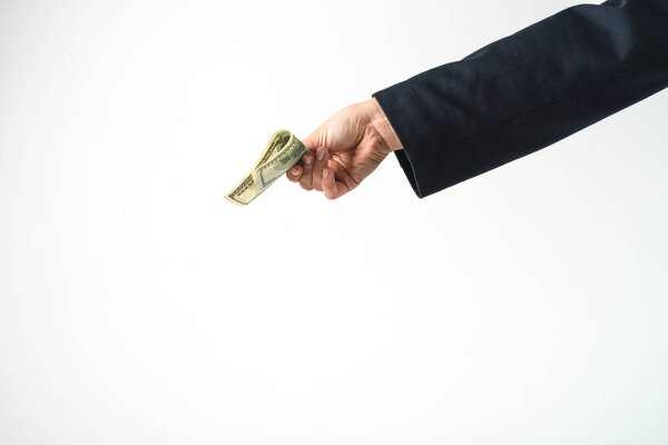 Рука держит американские доллары
