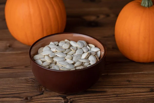 Fresh Orange Pumpkins Pimpkin Seeds Close Wooden Background — Stock Photo, Image