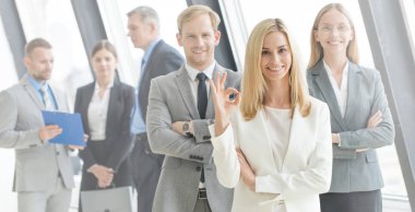 Business people showing ok sign clipart