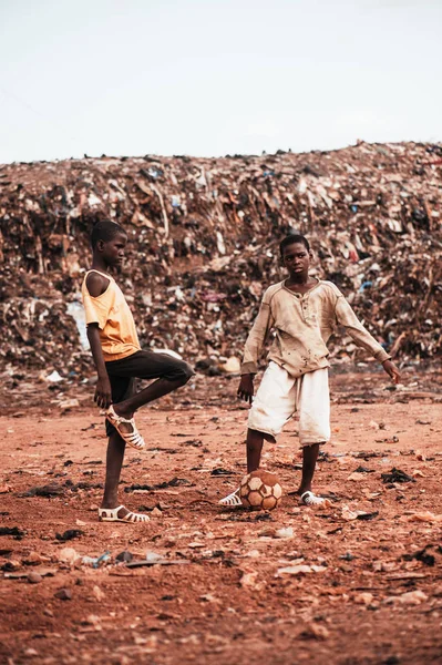 Niños negros africanos jugando fútbol con voluntarios caucásicos — Foto de Stock