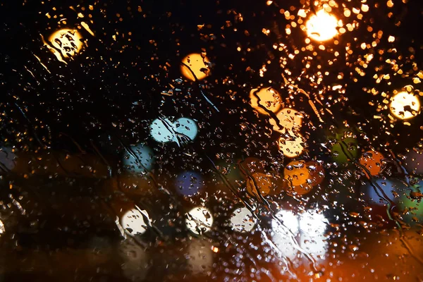 Rain drops on the window. Bokeh night city.