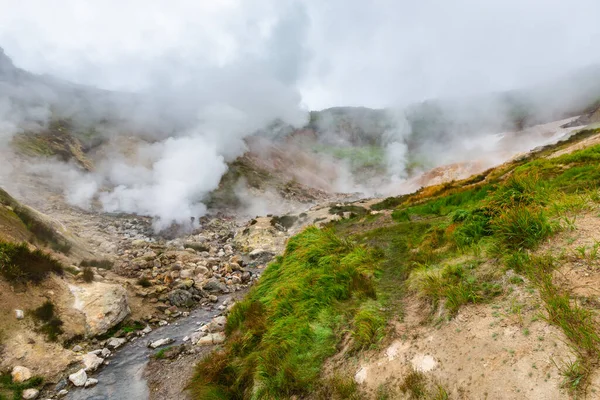 Picturesque view of volcanic landscape, aggressive hot spring, erupting fumarole, gas-steam activity in crater active volcano