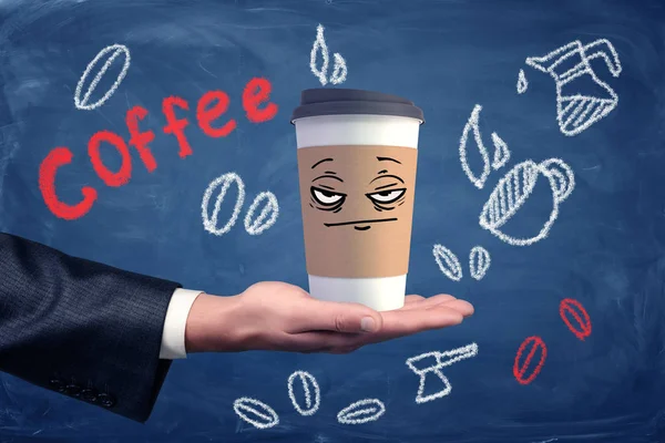 上に描かれた不幸な不機嫌そうな顔でコーヒー カップを持っている businessmans 手. — ストック写真