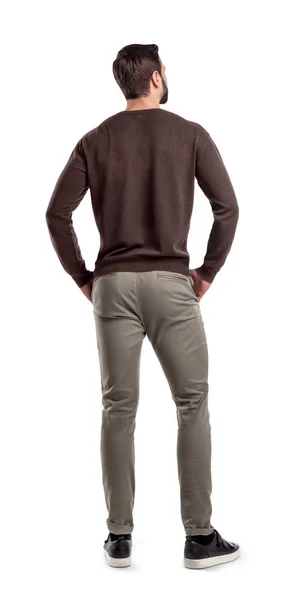 Μια πίσω όψη σε μια σύγχρονη προσαρμογή και ανέμελα με ρουχα άνθρωπος που στέκεται σε μια χαλαρή στάση και κοιτάζει λοξά. — Φωτογραφία Αρχείου