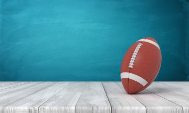 bir top Amerikan futbolu bir ahşap masa mavi bir arka plan üzerine yatan için 3D render.