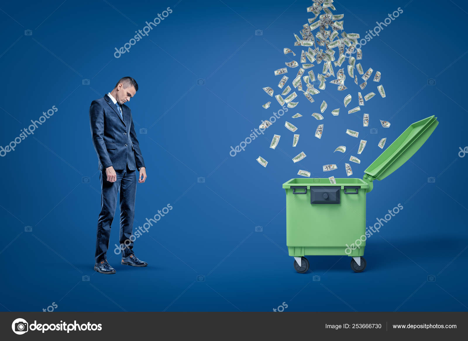 Sad Businessman Looking Down Standing Next To Open Dumspter With