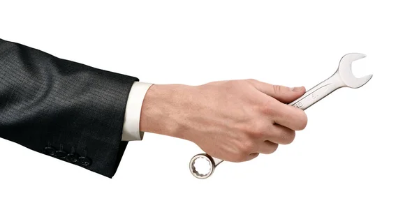 Мужская рука с серебряным гаечным ключом на белом фоне — стоковое фото