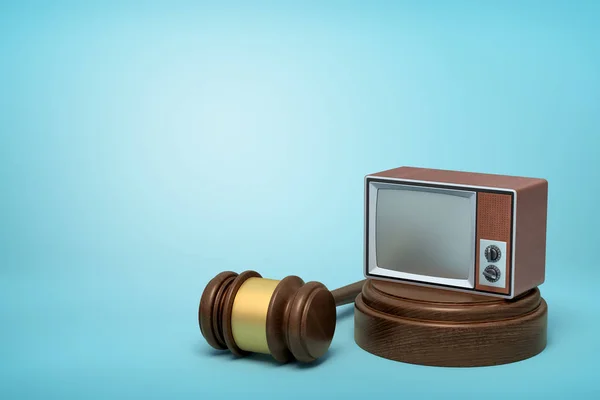 3d rendering of vintage tv set on round wooden block and brown wooden gavel on blue background