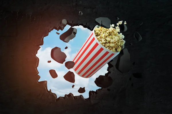3d rendering of popcorn bucket breaking black wall
