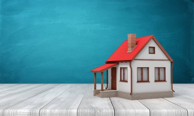 Bazı kopya alanı ile mavi duvara yakın ahşap zemin üzerinde duran küçük tek katlı evin 3d render.