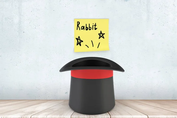 3d zbliżenie renderowanie czarny top kapelusz na drewnianej podłodze w pobliżu ściany z żółtą lepką nutą, która czyta Rabbit. — Zdjęcie stockowe