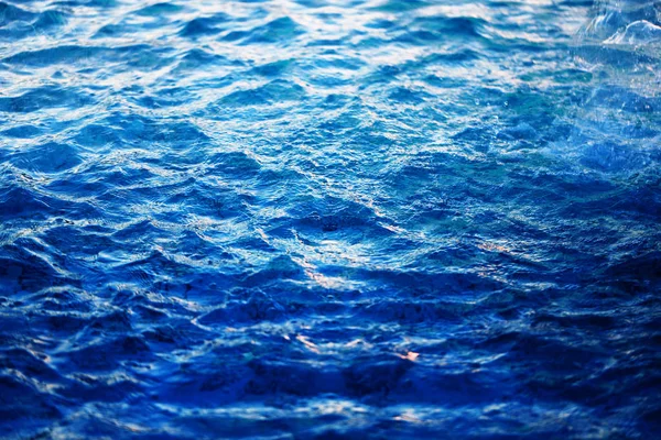 Macro photo background with transparent blue waves of sea